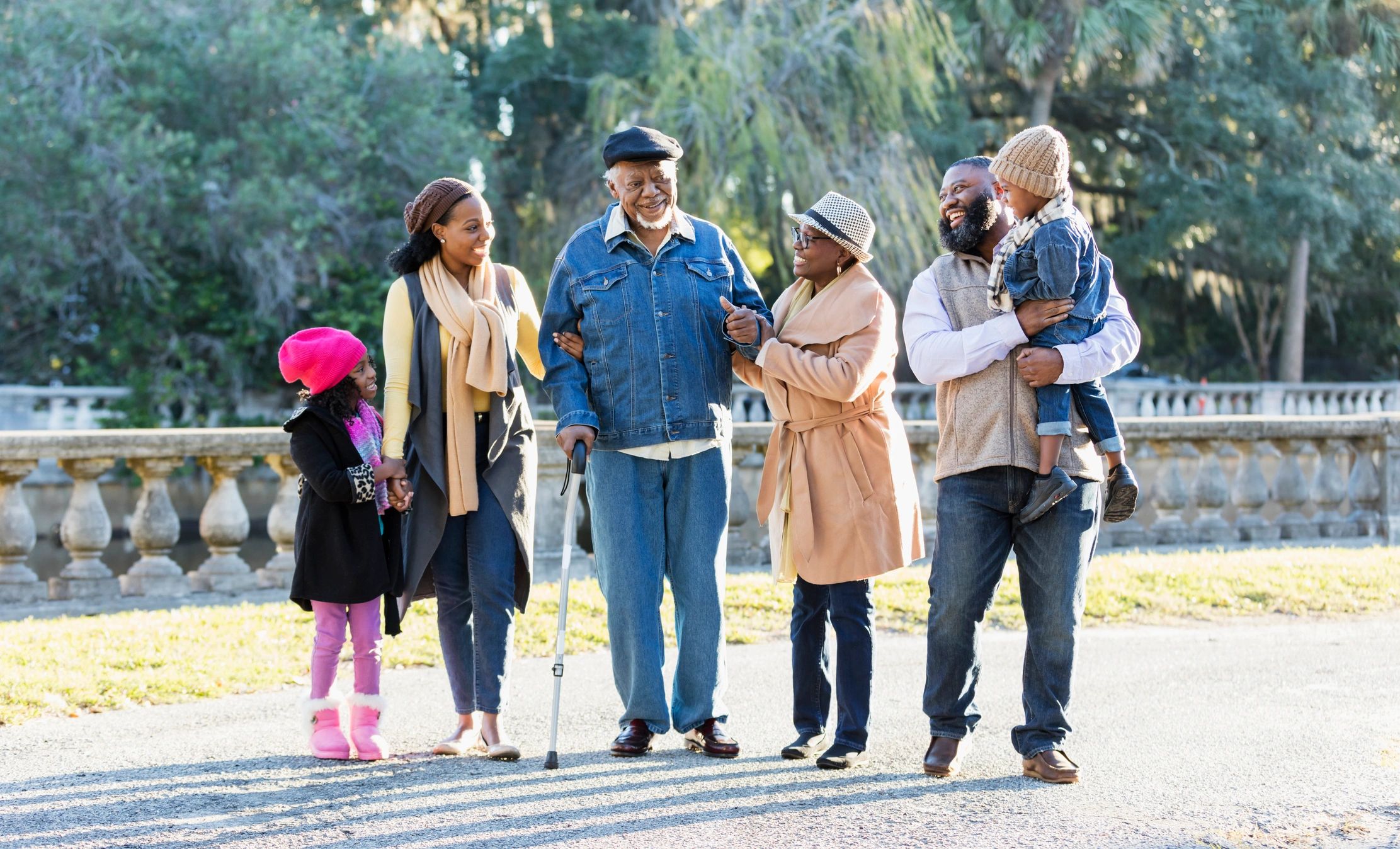 Family walking together while supporting an older loved one