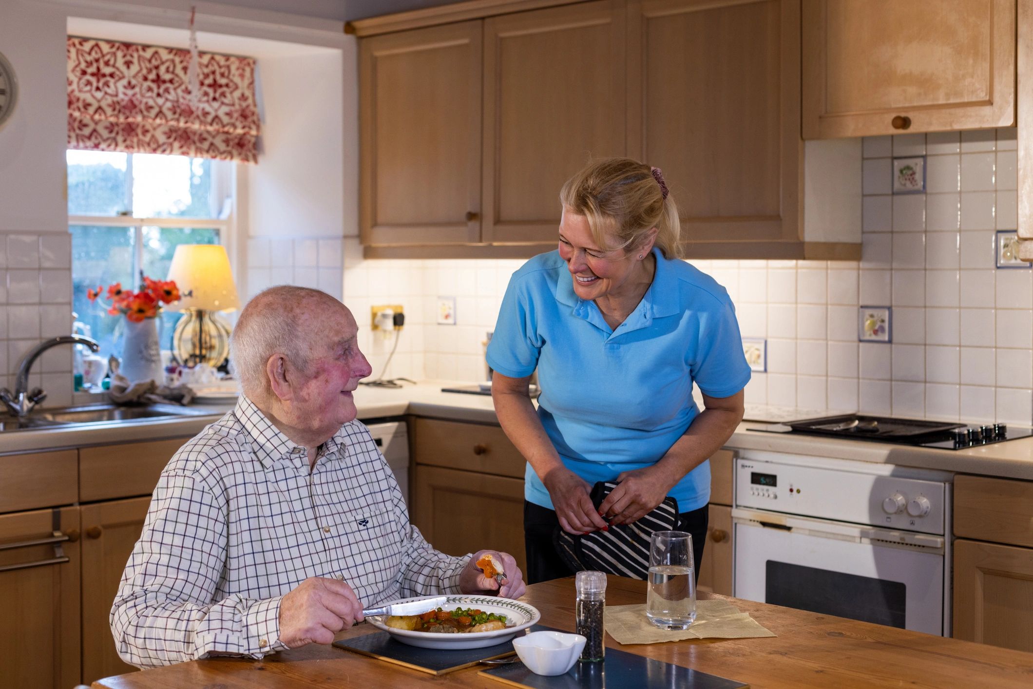 Caregiver sharing a warm moment with a senior at home