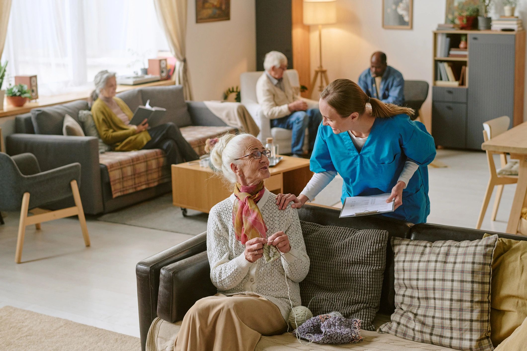 Care professional speaking with a senior woman during a home visit