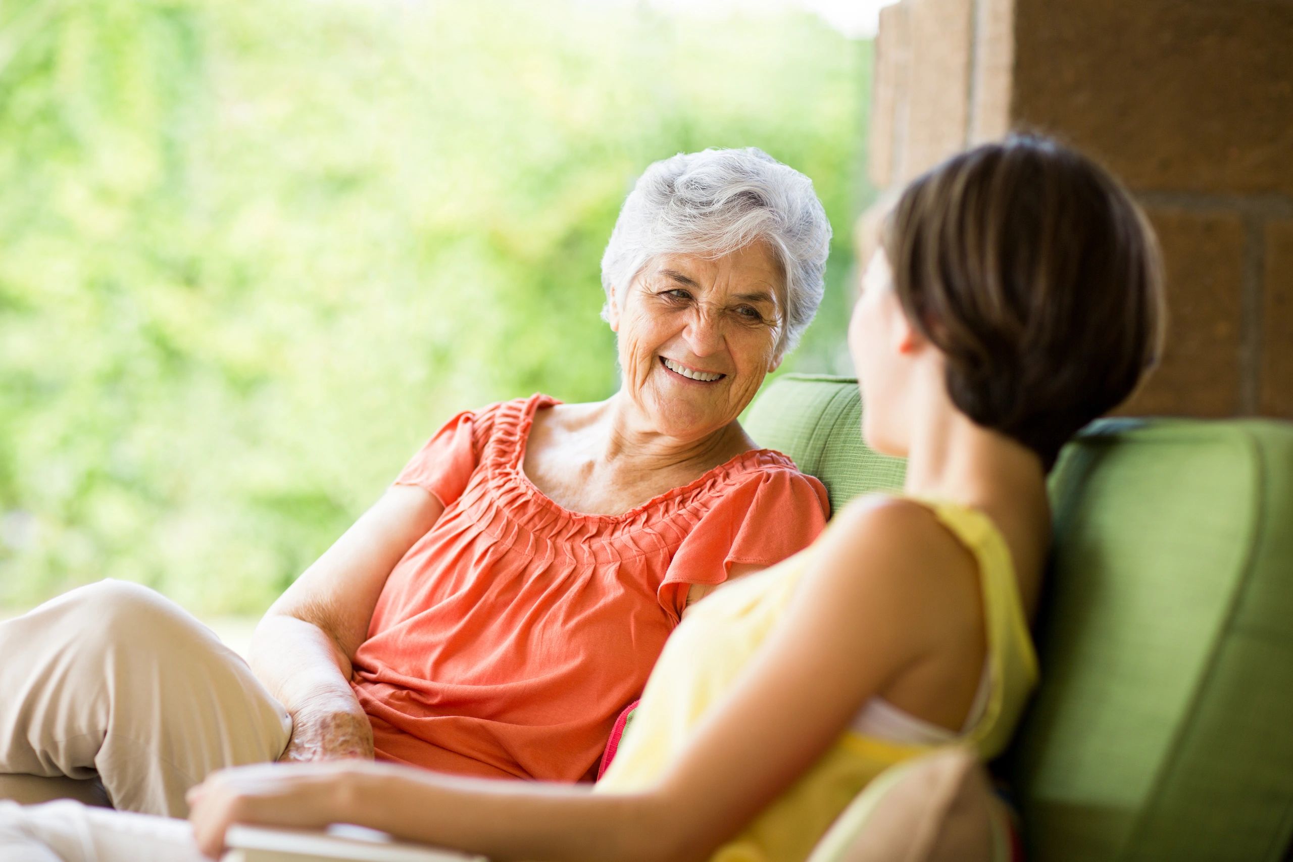 Young woman chatting with her grandmother